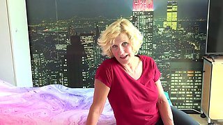 Beautiful mommy is alone on her bed masturbating