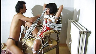 Submissively, he ties up her body