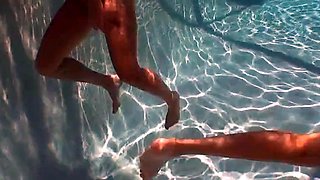 Young lesbian friends going down on each other in the pool