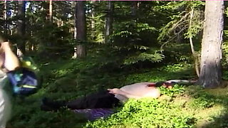 Mistress pisses on her slave in the forest.