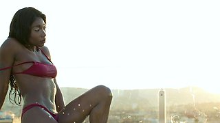 Petite Ebony MILF strips naked in a pool