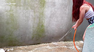 Maid in pajamas cleaning the yard