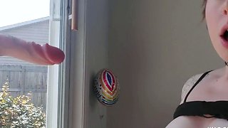 Sucking Dildo in Front of Window