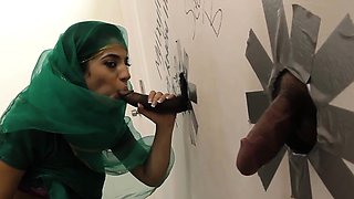 Nadia Ali having fun with black cock in a gloryhole