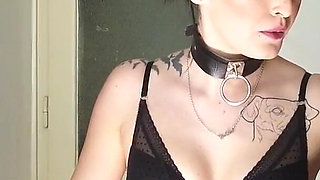 Tattooed gothic lady smoking in the kitchen