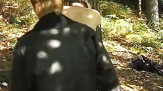 A mature German domina spanks her man in the woods