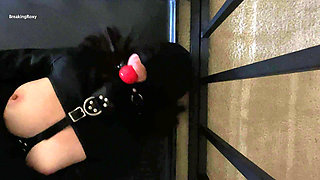 Gagged and Hooded Slave struggles in Straitjacket While In Cage
