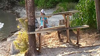 Ashlyn Lee goes fishing, but she would rather enjoy a masturbation session on the sand. She gets caught on-camera by our voyeur videographer.