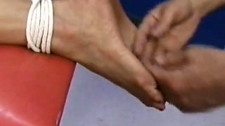 Sexy girl gets tits pinched while her legs and hands are bound