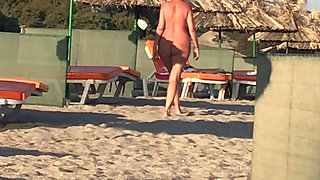 She pisses on the nudist beach