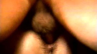 In a kitchen a sexy brunette playing with her big boobs