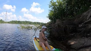 Big-Ass Blonde Rides a SUP Board Naked on a Beach