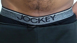 A sexy guy is dancing while holding his cock.