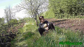 Pissing in grass on the side of the road