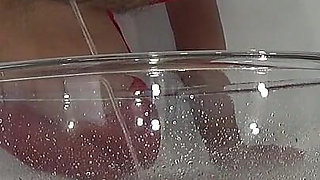 A MILF in Red Is Peeing Into a Basin.