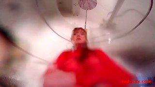 MILF Red shoves a dildo in her pussy while taking a shower