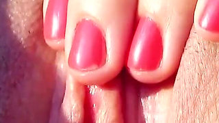 Two lesbian teens pamper each other on vacation at the pool