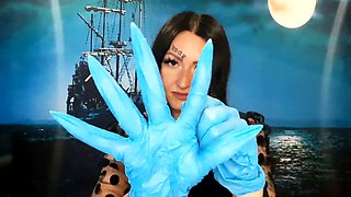 Dominatrix Nika with a glove fetish puts on medical gloves and destroys them with her long tools