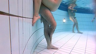 A young Latin couple has sex underwater in a public pool