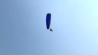 Busty MILF In Green Bikini Handjobs Her Partner On A Public Beach