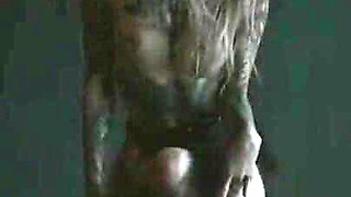 Tattooed teen is dancing in the dark room