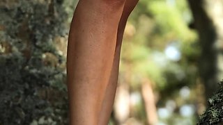 Slender German MILF strips nude outdoors