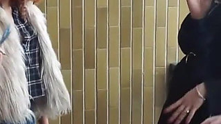 Fur-clad Femdoms Dominate Submissive on Balcony